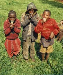 Street children brothers pose with their glue sticks