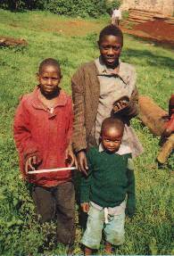 Three street children pose together